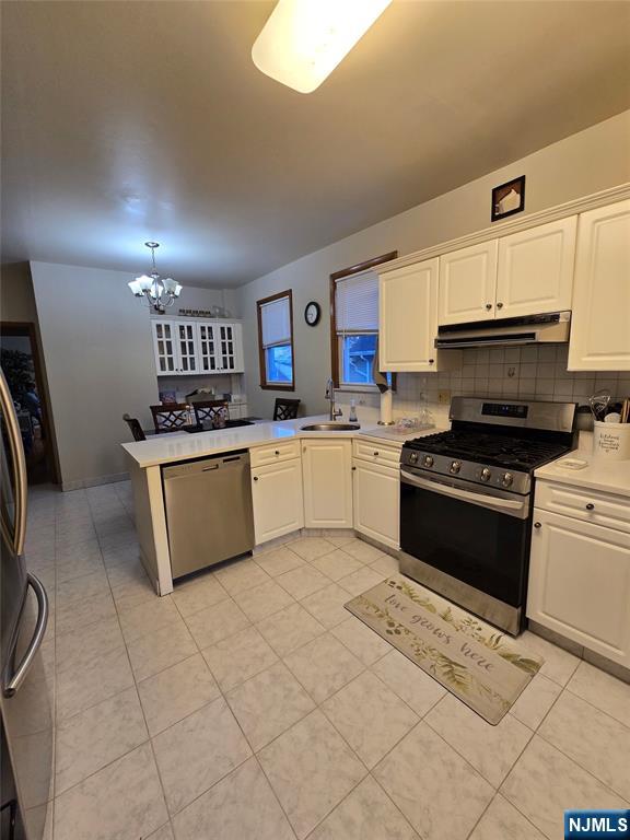 50 Columbia Avenue, Unit 2 Kearny, NJ 07032 - Photo 10 of 11 a kitchen with stainless steel appliances granite countertop a sink and a stove top oven with white cabinets