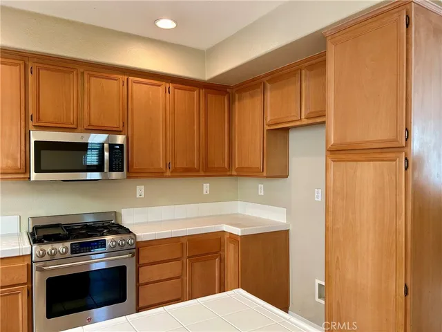 a kitchen with a stove microwave and sink