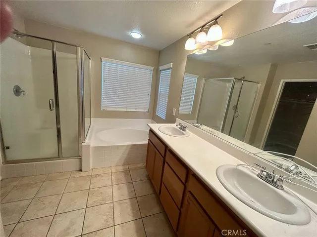 a bathroom with a sink a toilet a mirror and shower