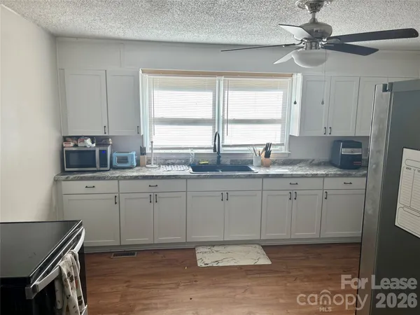 a kitchen with a sink cabinets and window
