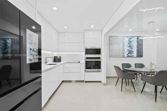 a kitchen with stainless steel appliances kitchen island granite countertop a stove a sink and a refrigerator