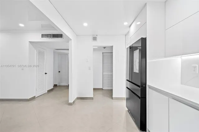 a view of hallway with stainless steel appliances