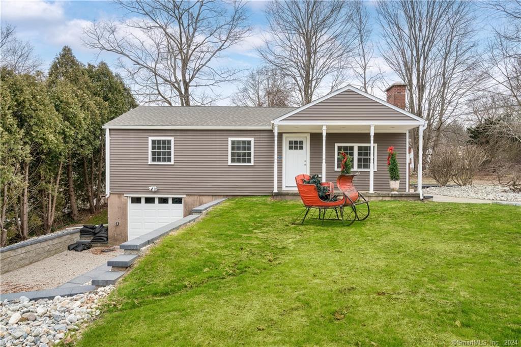 a front view of house with yard and green space