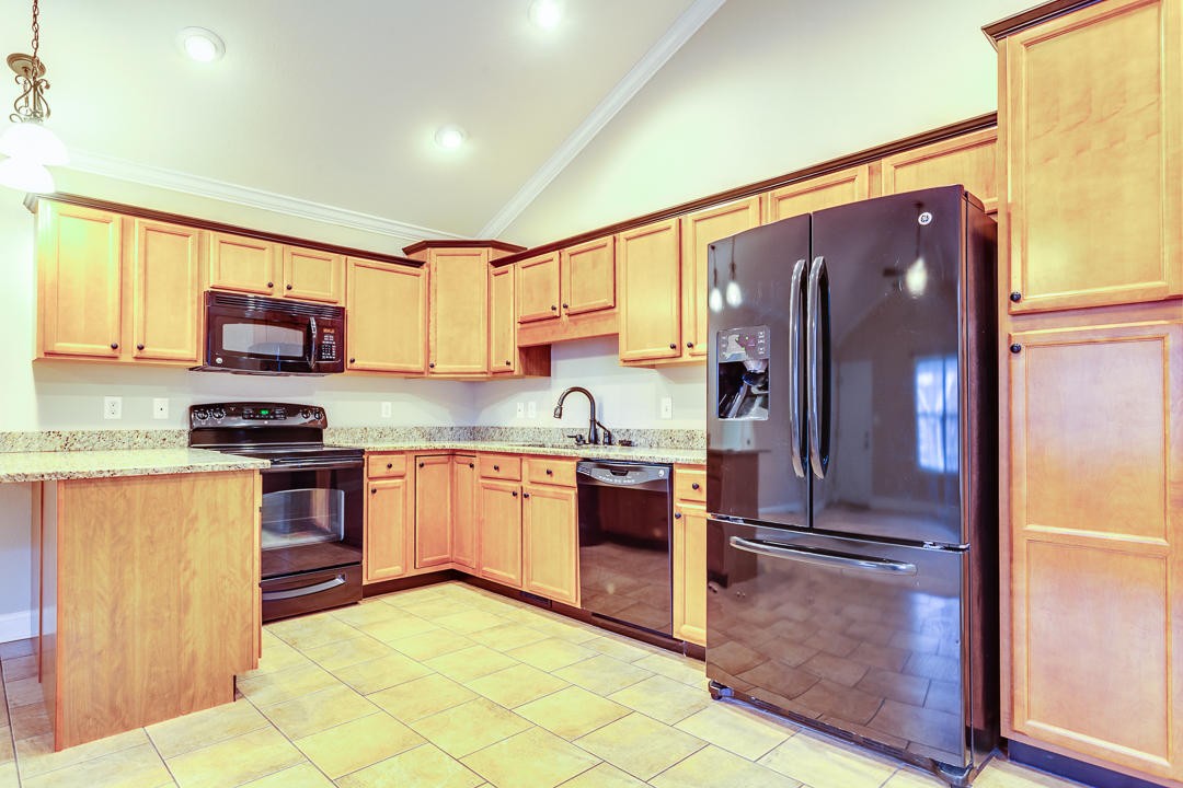 6067 Whisper Ridge Lane Corryton, TN 37721 - Photo 14 of 35 a kitchen with stainless steel appliances granite countertop a refrigerator stove and sink