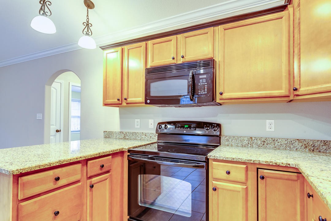 6067 Whisper Ridge Lane Corryton, TN 37721 - Photo 17 of 35 a kitchen with stainless steel appliances granite countertop a sink a stove and cabinets