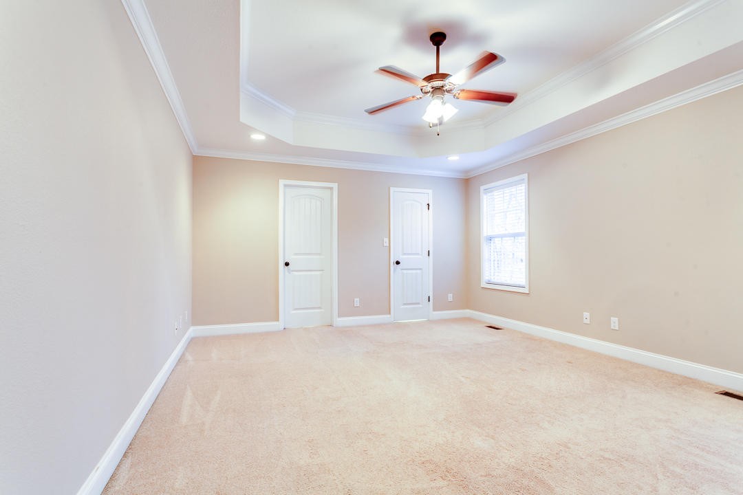 6067 Whisper Ridge Lane Corryton, TN 37721 - Photo 18 of 35 an empty room with chandelier fan and windows