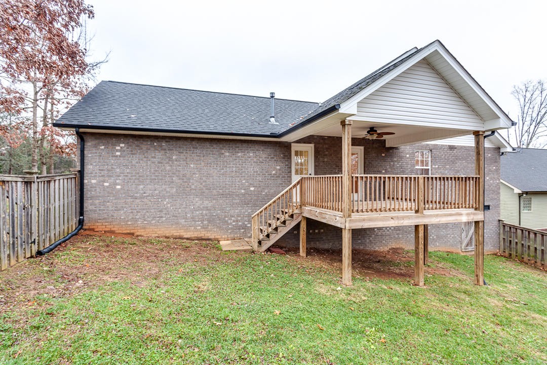 6067 Whisper Ridge Lane Corryton, TN 37721 - Photo 34 of 35 a backyard of a house with table and chairs