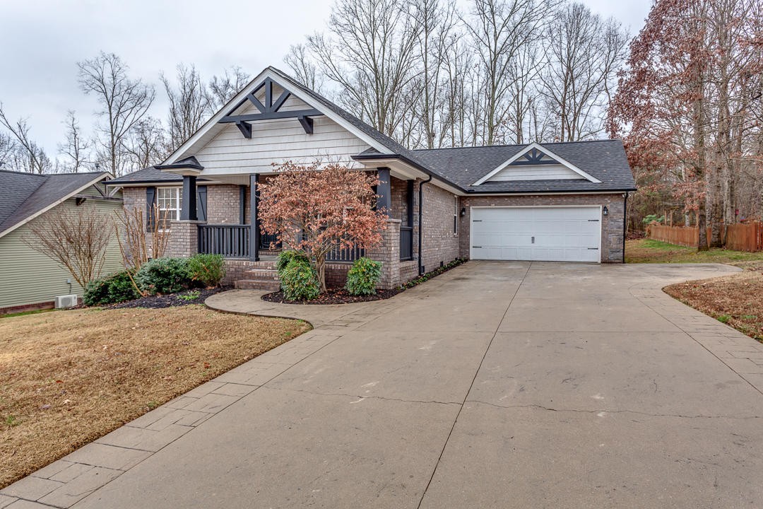 6067 Whisper Ridge Lane Corryton, TN 37721 - Photo 4 of 35 a front view of a house with a yard and garage