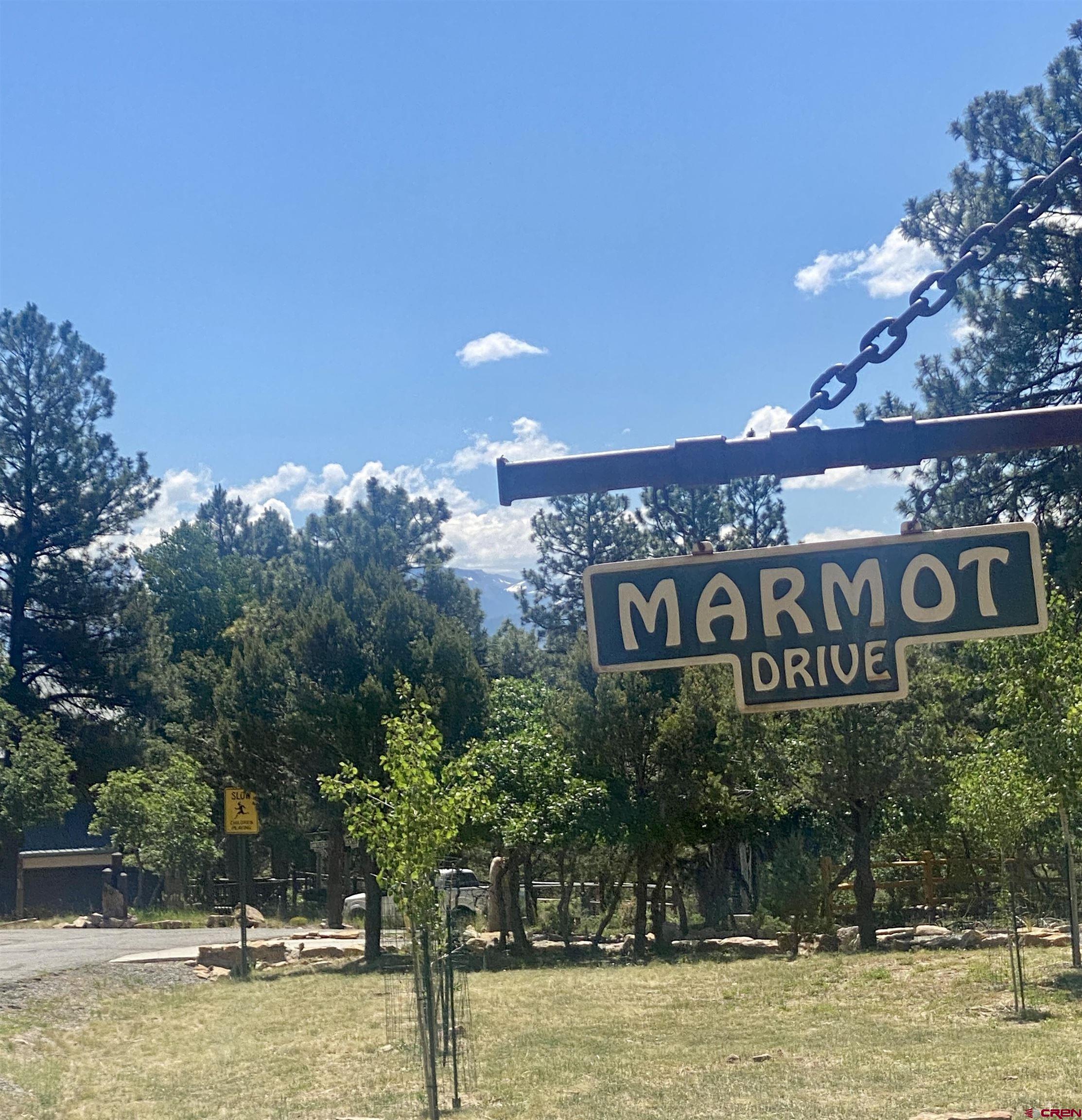 935 Marmot Drive Ridgway, CO 81432 - Photo 22 of 24 a view of a sign board with yard and lake view