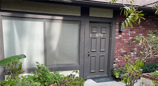 a couple of potted plants in front of door