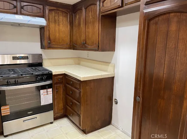 a kitchen with stainless steel appliances granite countertop a stove and a microwave oven