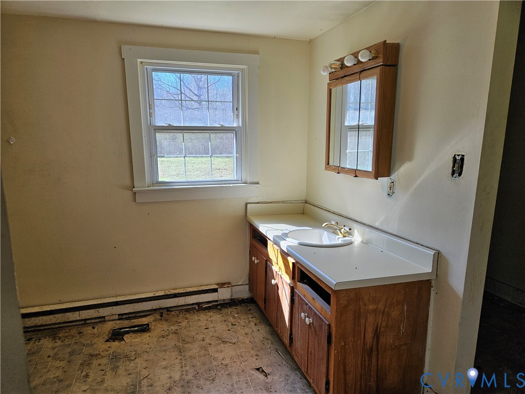 10030 Cheathams Road Amelia Court House, VA 23002 - Photo 12 of 23 a utility room with a stove a washer and dryer