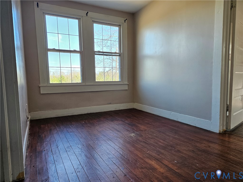 10030 Cheathams Road Amelia Court House, VA 23002 - Photo 16 of 23 an empty room with wooden floor and windows