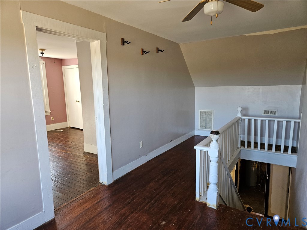 10030 Cheathams Road Amelia Court House, VA 23002 - Photo 18 of 23 a view of a livingroom with wooden floor and staircase