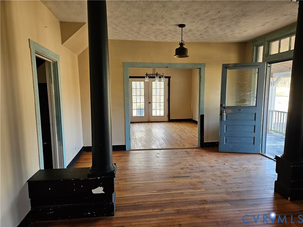 10030 Cheathams Road Amelia Court House, VA 23002 - Photo 4 of 23 a view of a hallway with wooden floor and staircase