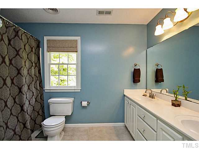 1117 Urania Drive Raleigh, NC 27603 - Photo 14 of 25 a bathroom with a sink a toilet and shower