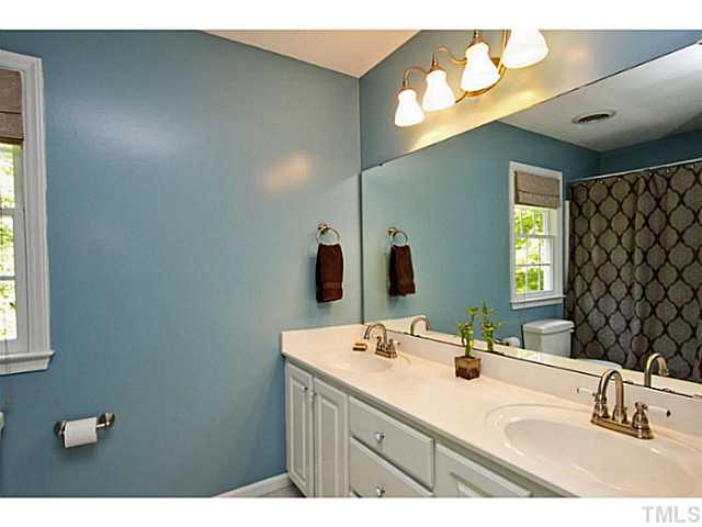 1117 Urania Drive Raleigh, NC 27603 - Photo 15 of 25 a bathroom with a sink and a mirror