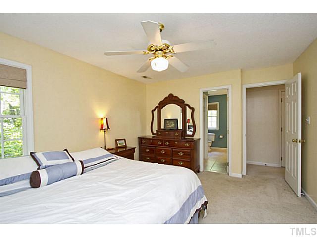 1117 Urania Drive Raleigh, NC 27603 - Photo 17 of 25 a bedroom with a bed and a chandelier