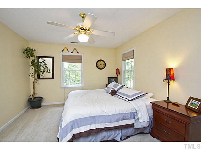 1117 Urania Drive Raleigh, NC 27603 - Photo 18 of 25 a bedroom with a bed and a chandelier