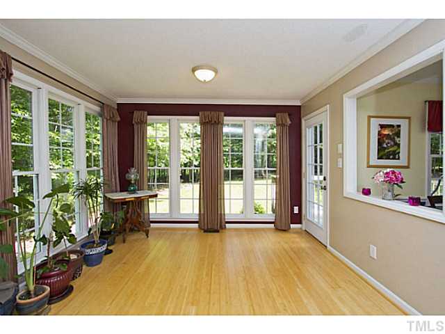 1117 Urania Drive Raleigh, NC 27603 - Photo 6 of 25 a living room with hardwood floor and a large window