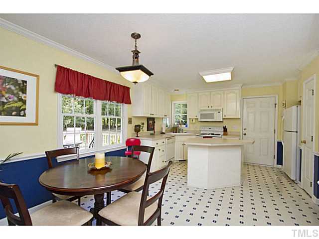 1117 Urania Drive Raleigh, NC 27603 - Photo 7 of 25 a view of a dining room with furniture a chandelier and wooden floor