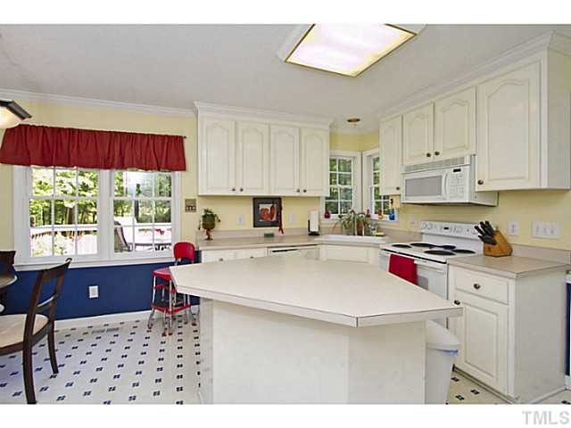 1117 Urania Drive Raleigh, NC 27603 - Photo 9 of 25 a kitchen with a stove a sink dishwasher and a refrigerator