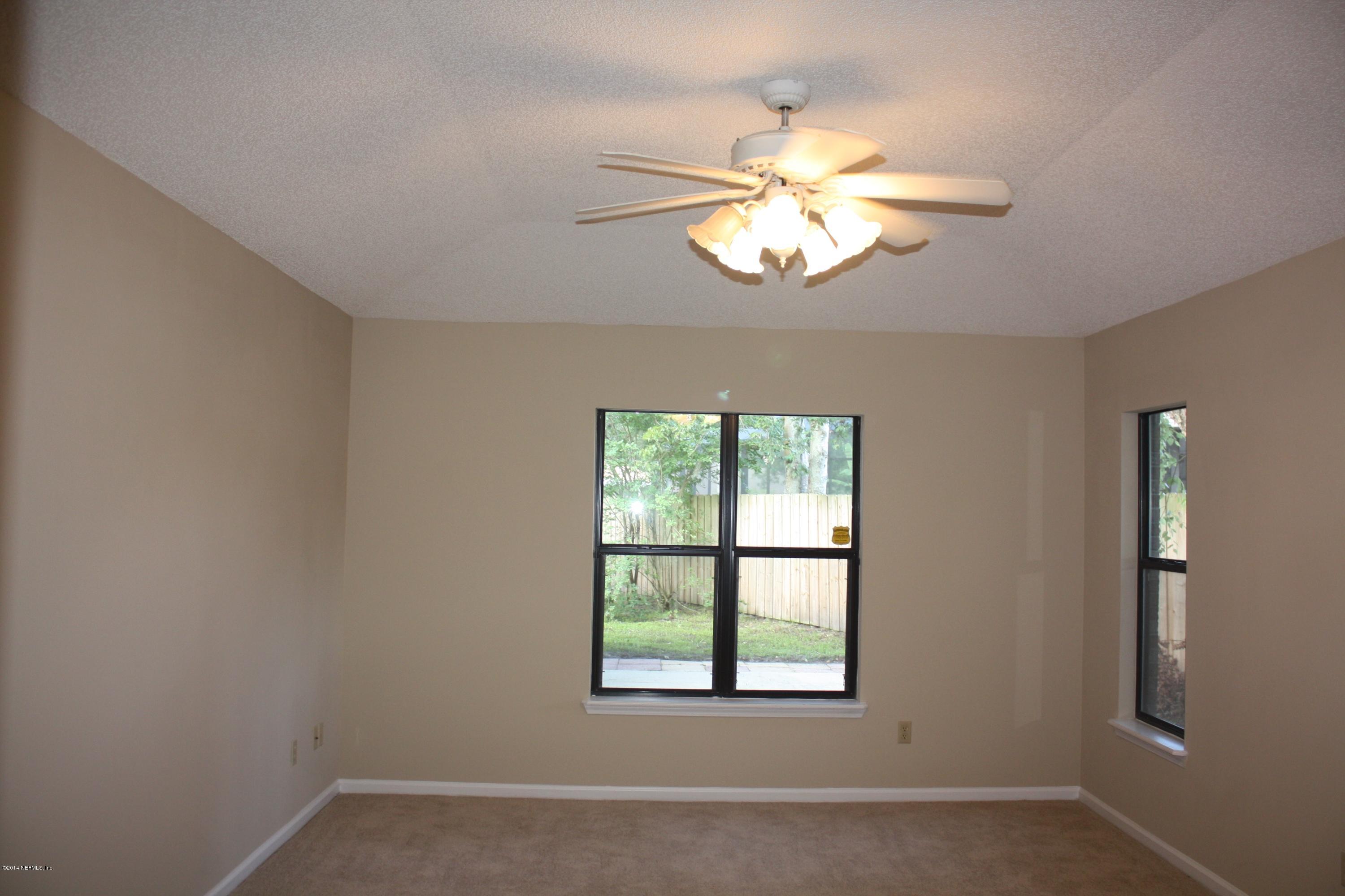 3060 Nautilus Road Middleburg, FL 32068 - Photo 17 of 40 an empty room with windows and fan