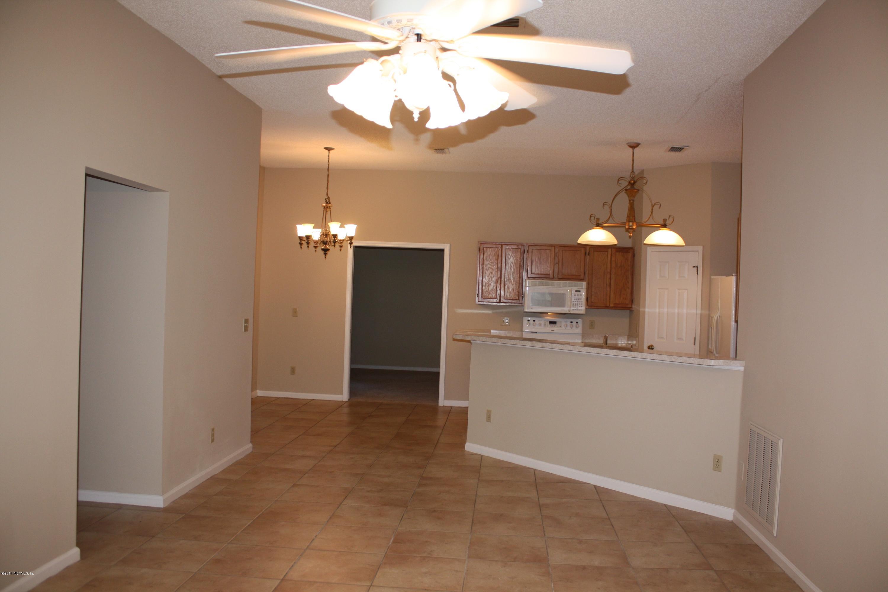 3060 Nautilus Road Middleburg, FL 32068 - Photo 9 of 40 a view of a kitchen with a sink and refrigerator