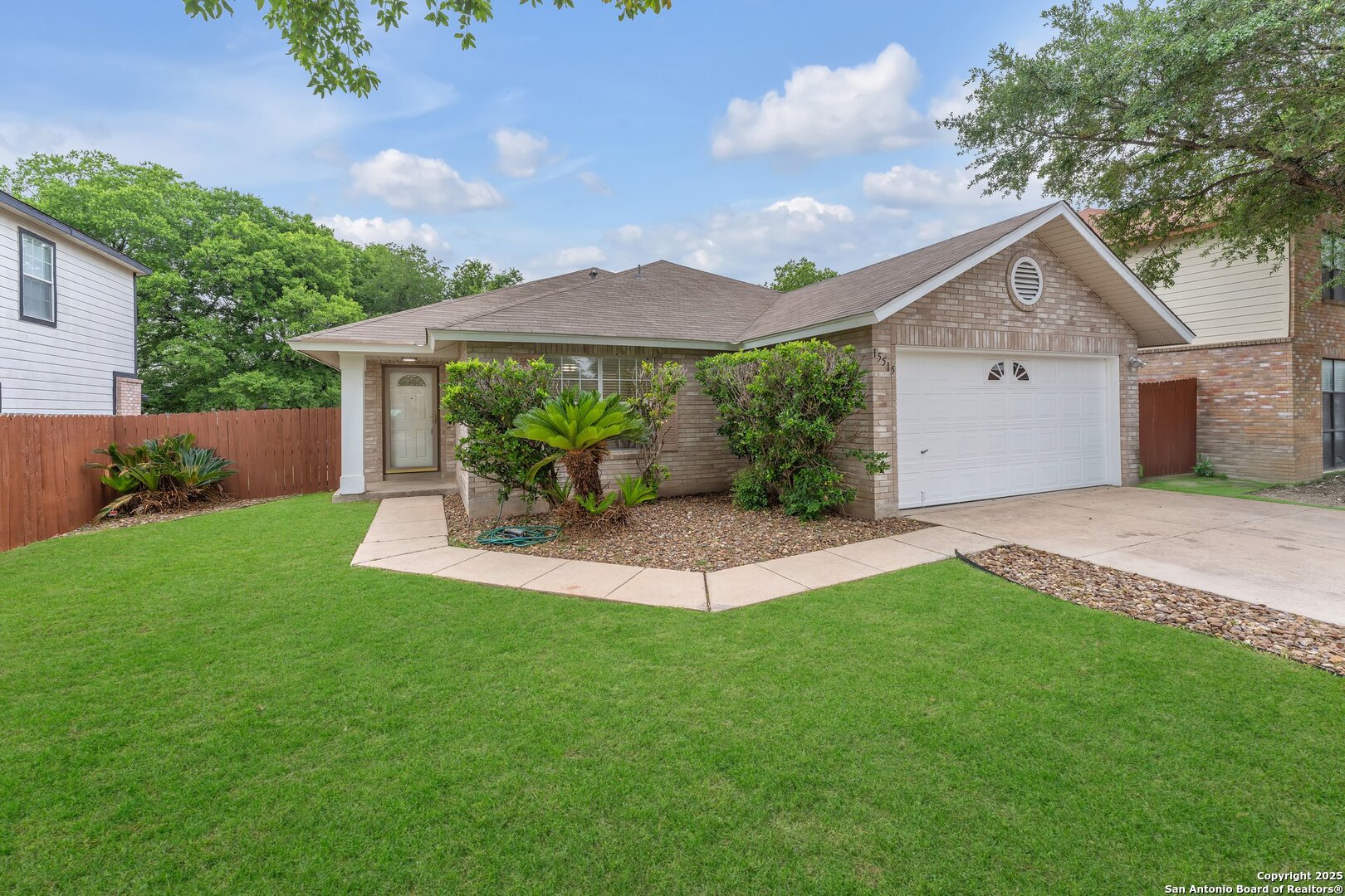 15515 Spring Summit San Antonio, TX 78247 - Photo 1 of 36 a view of a house with a yard and a garden