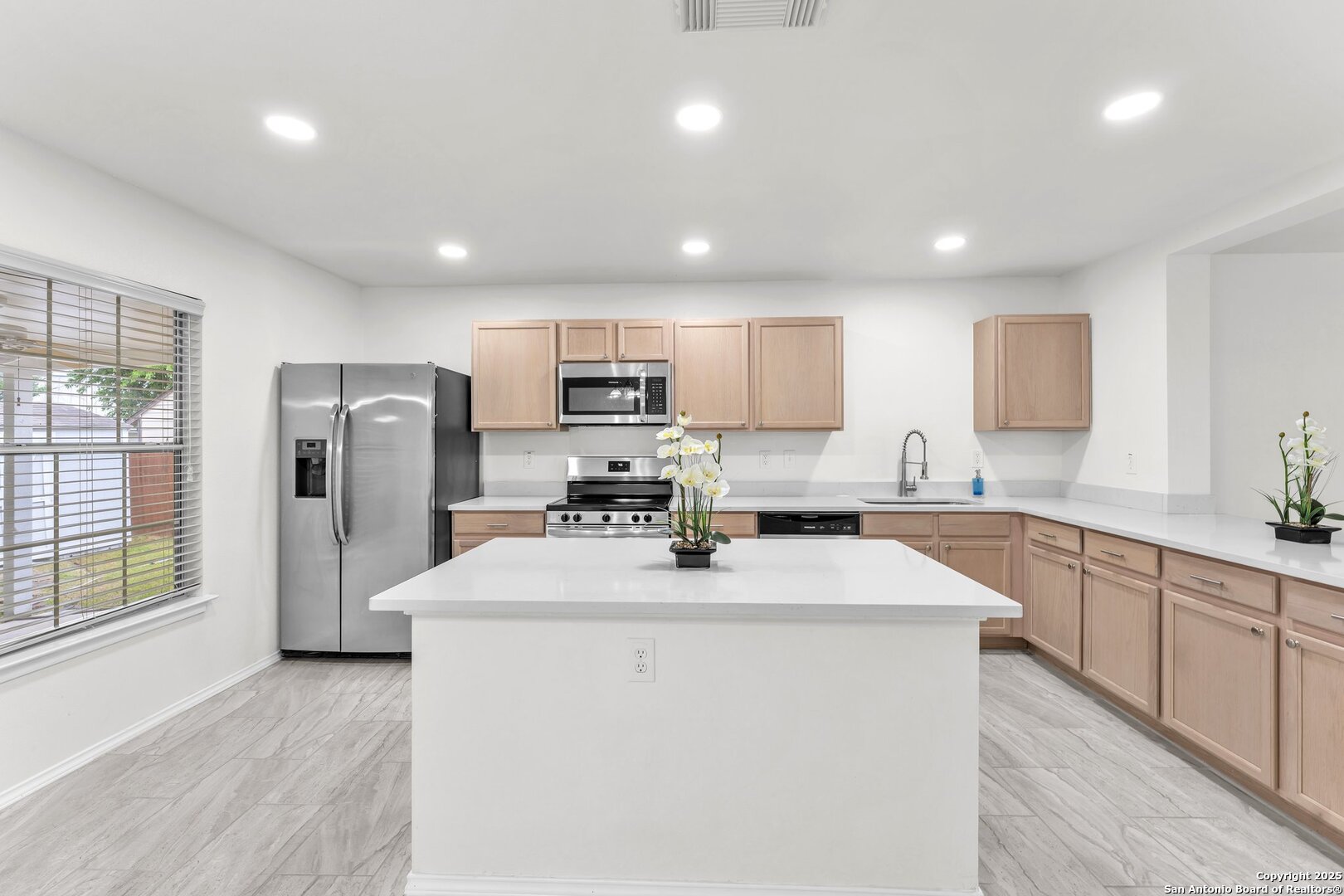 15515 Spring Summit San Antonio, TX 78247 - Photo 11 of 36 a kitchen with refrigerator cabinets and wooden floor