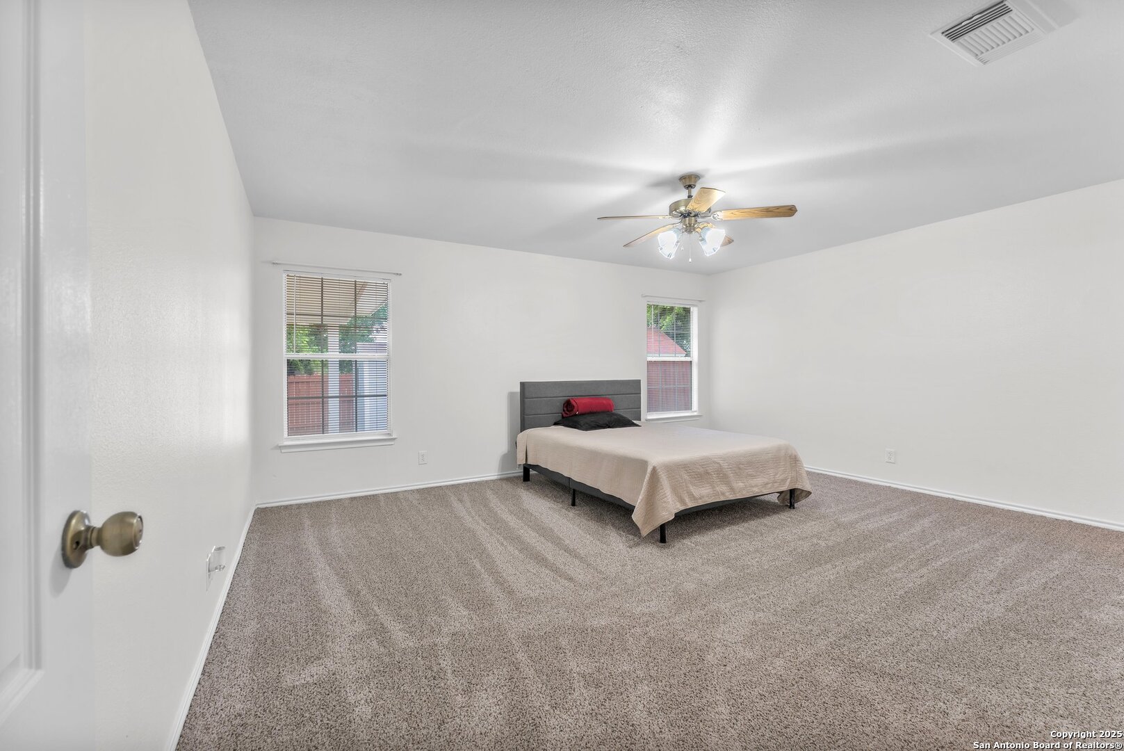 15515 Spring Summit San Antonio, TX 78247 - Photo 24 of 36 a bedroom with a bed and a ceiling fan in it