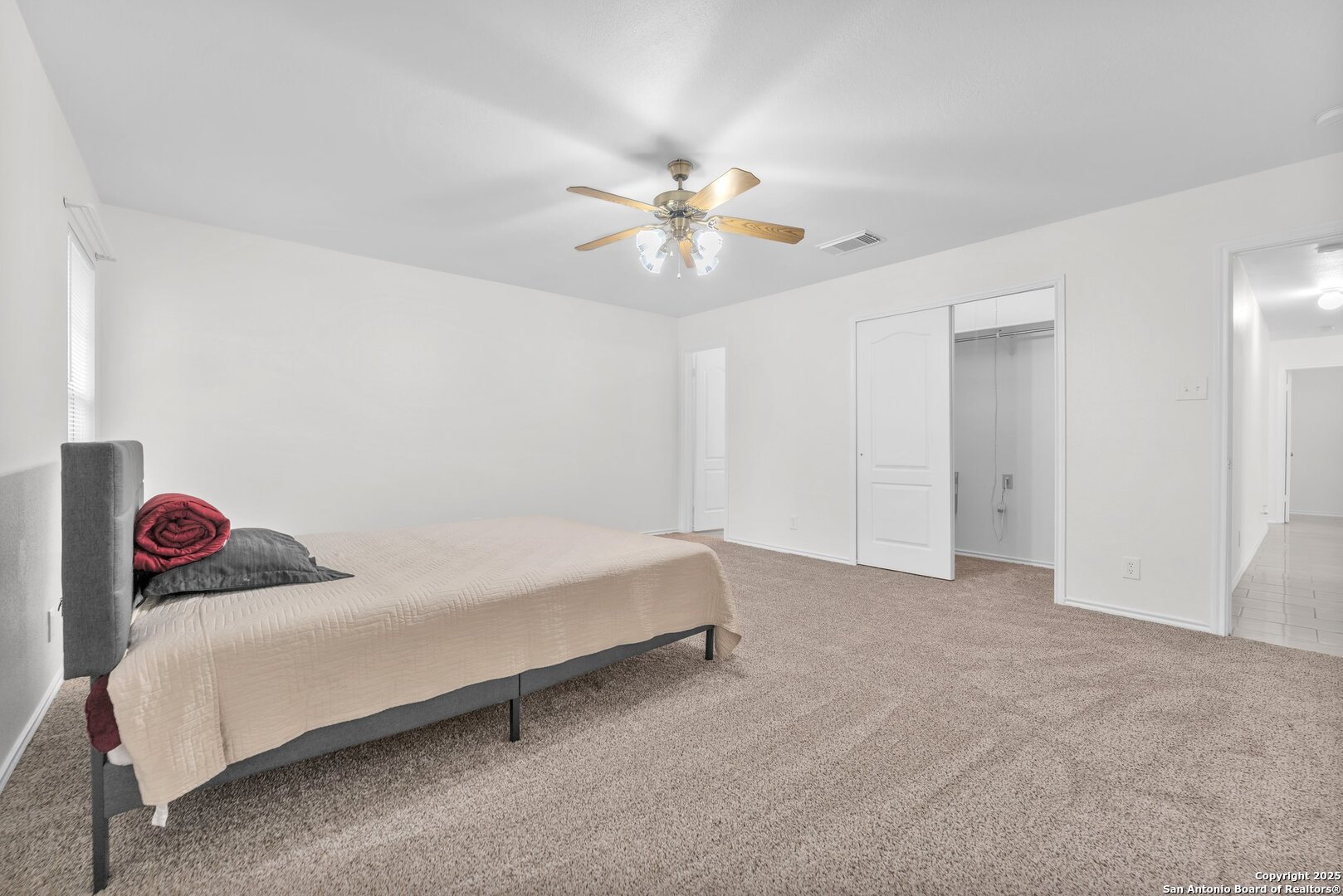 15515 Spring Summit San Antonio, TX 78247 - Photo 25 of 36 a bedroom with a bed and a chandelier