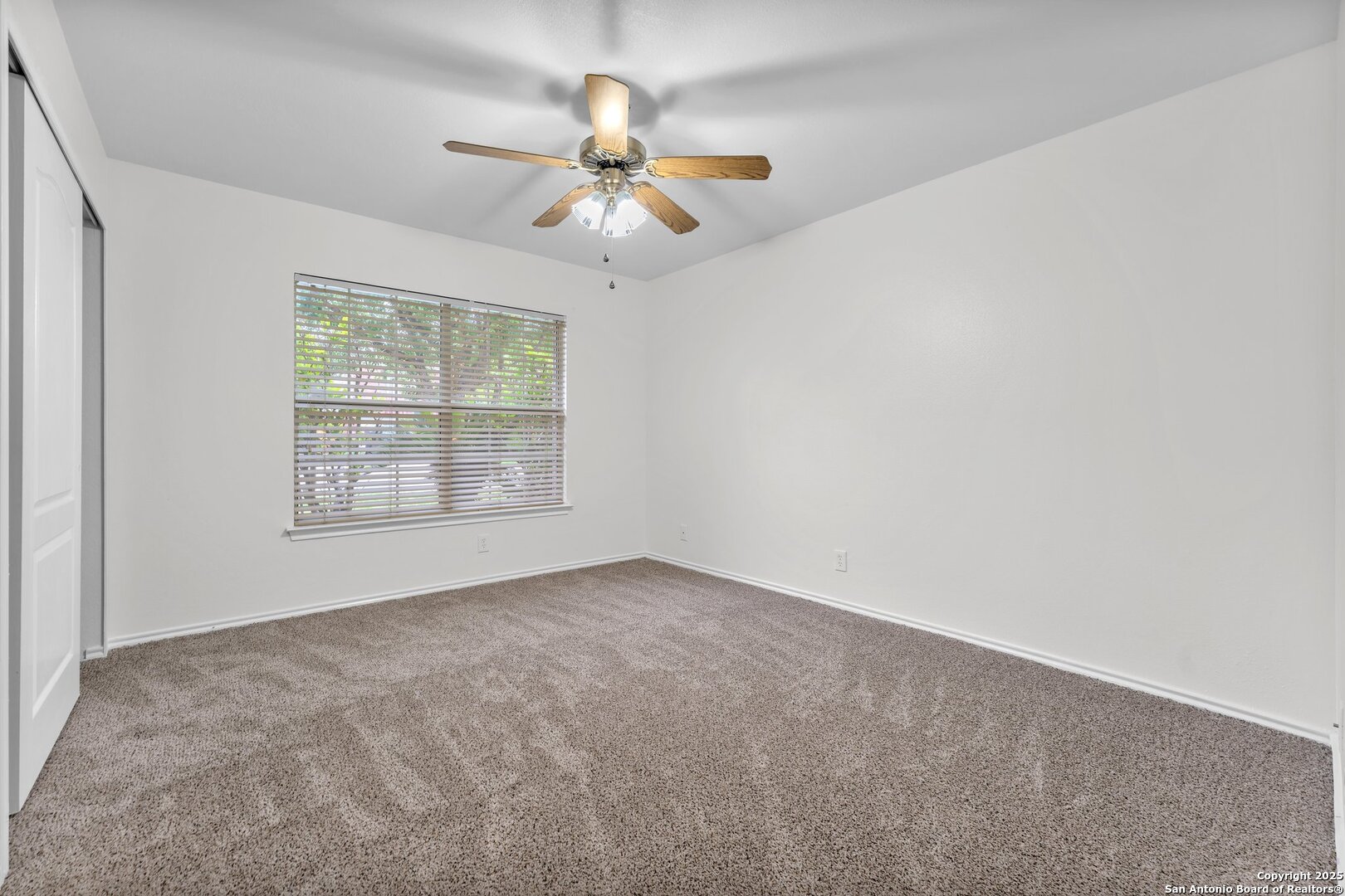 15515 Spring Summit San Antonio, TX 78247 - Photo 30 of 36 an empty room with windows and chandelier fan