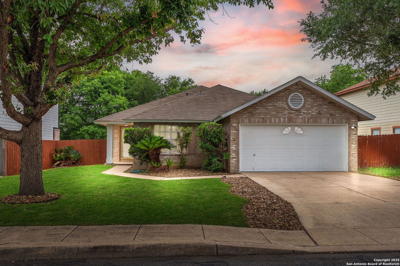 15515 Spring Summit San Antonio, TX 78247 - Photo 4 of 36 a front view of a house with a yard and garage