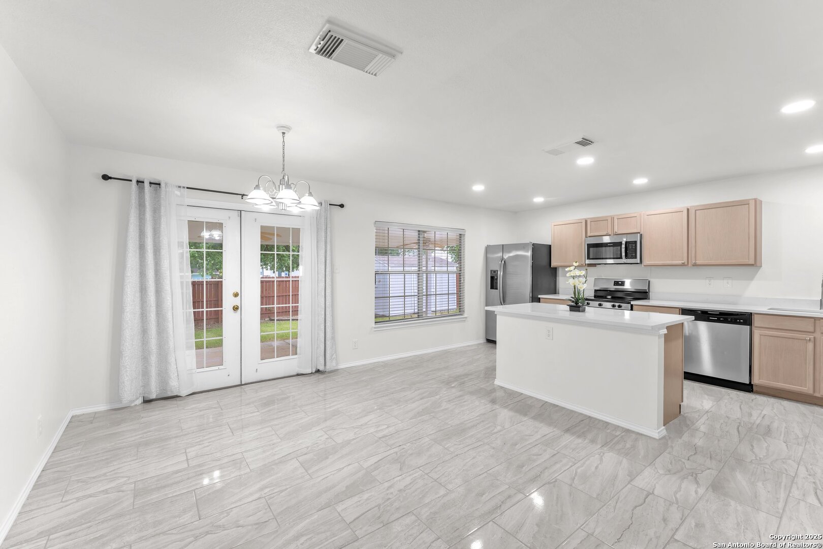 15515 Spring Summit San Antonio, TX 78247 - Photo 9 of 36 a large white kitchen with granite countertop a large counter top stainless steel appliances and cabinets