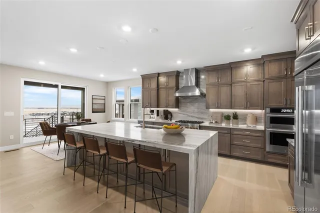 a kitchen with appliances a sink and cabinets