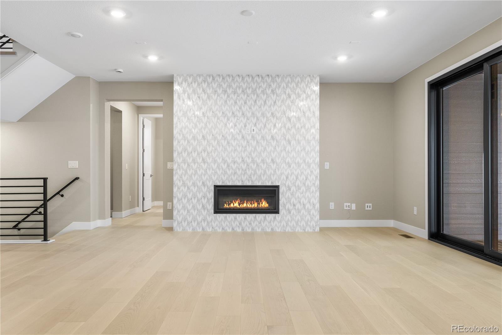 11293 Tenor Trail Lone Tree, CO 80134 - Photo 15 of 50 an empty room with windows and fireplace