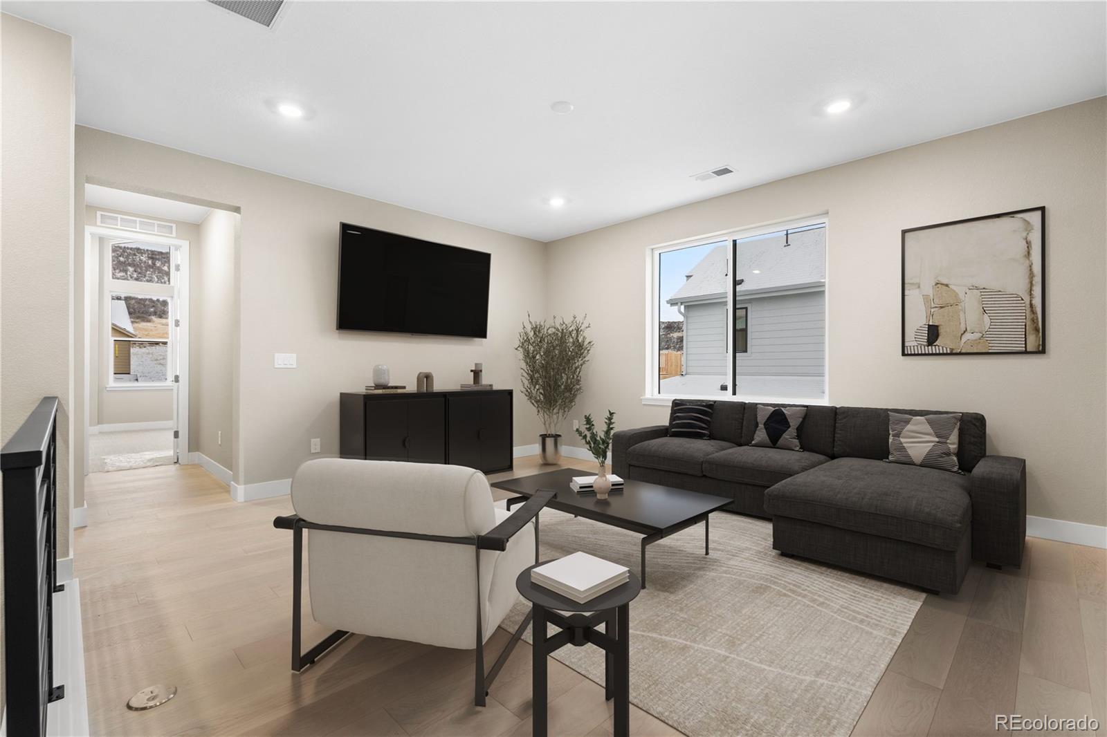11293 Tenor Trail Lone Tree, CO 80134 - Photo 16 of 50 a living room with furniture and a flat screen tv
