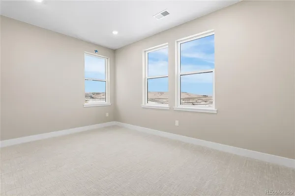 an empty room with windows and closet