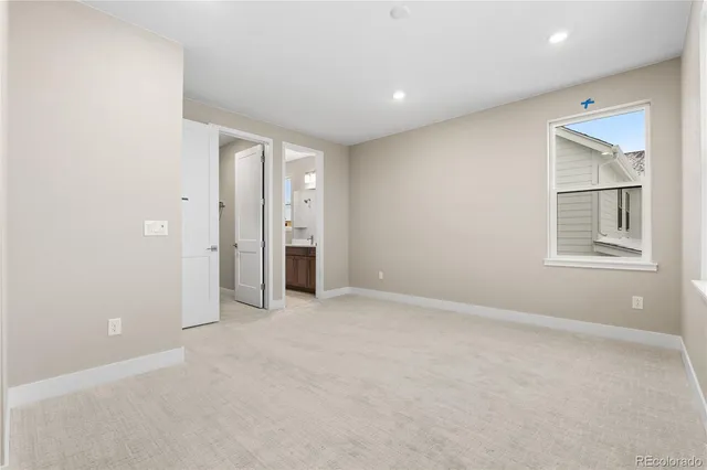 an empty room with windows and closet