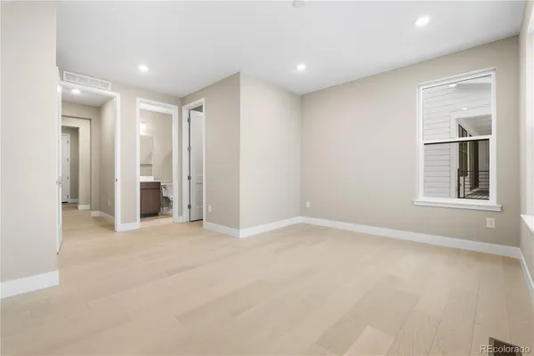 an empty room with windows and closet