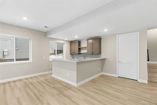 a view of kitchen with wooden floor and electronic appliances