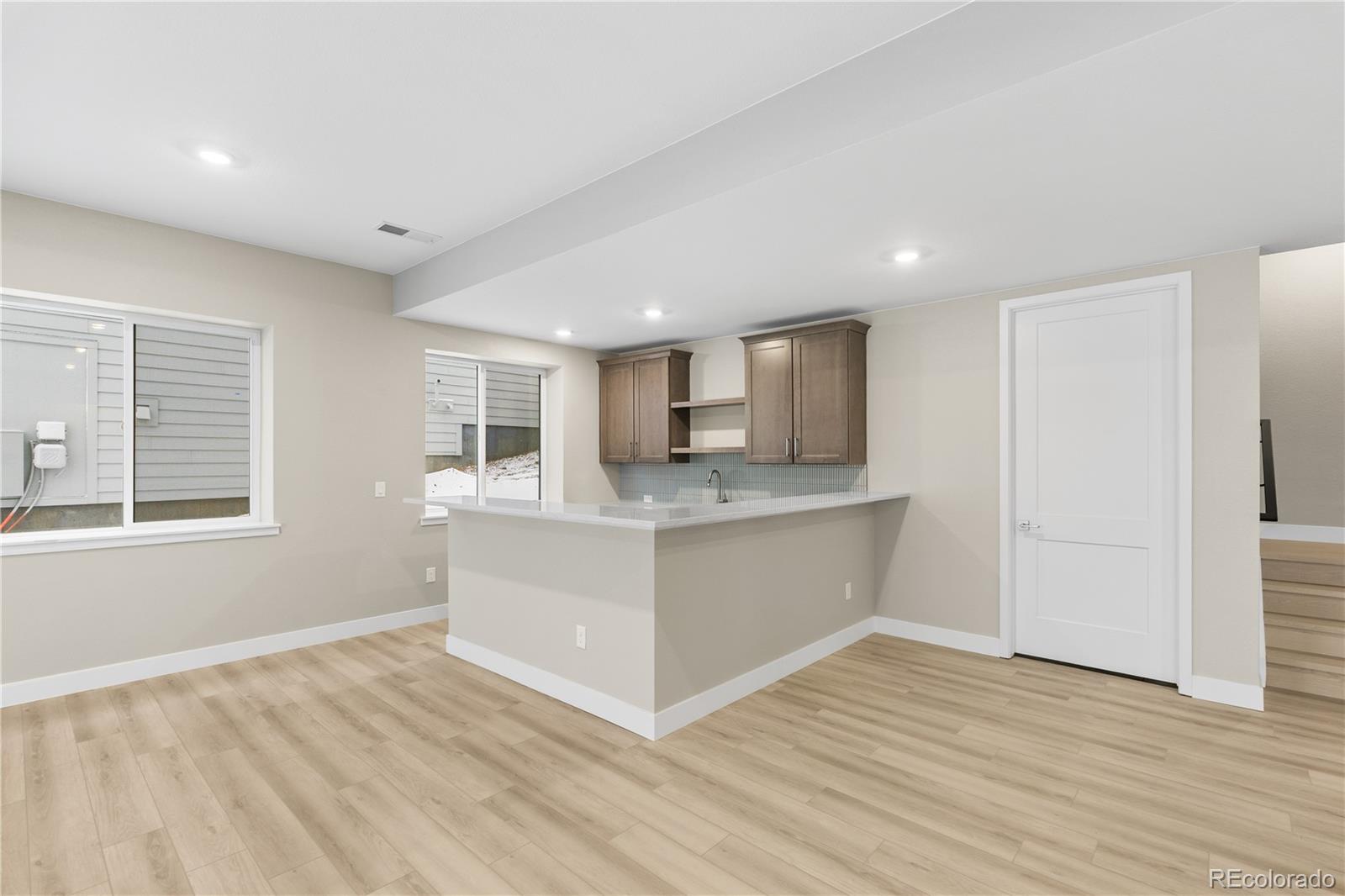 11293 Tenor Trail Lone Tree, CO 80134 - Photo 23 of 50 a view of kitchen with wooden floor and electronic appliances