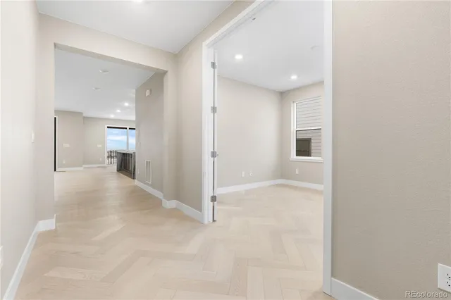 a view of a hallway with wooden shelves