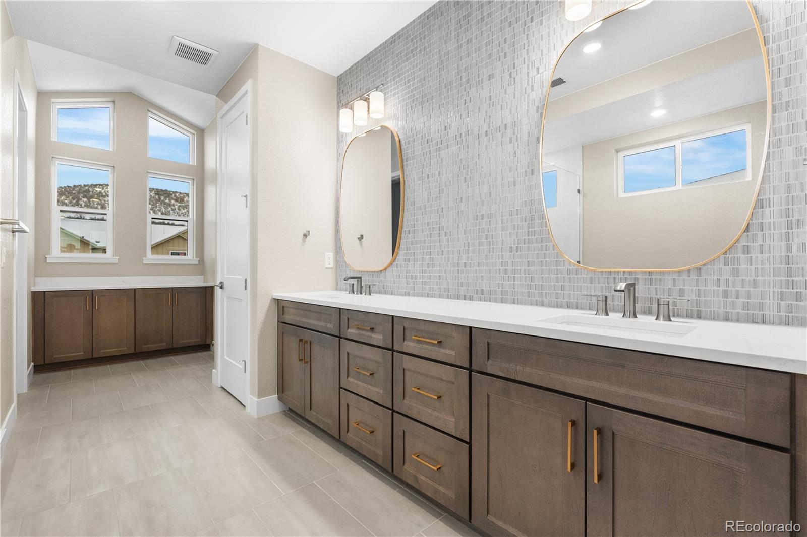 11293 Tenor Trail Lone Tree, CO 80134 - Photo 32 of 50 a spacious bathroom with a double vanity sink mirror double and bathtub