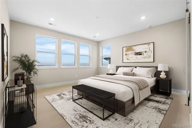 a bedroom with a large bed and a window