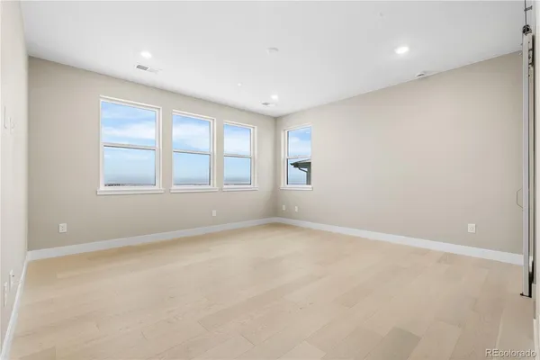 an empty room with windows and closet
