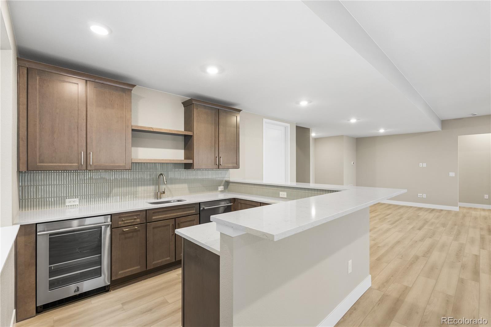 11293 Tenor Trail Lone Tree, CO 80134 - Photo 4 of 50 a kitchen with a sink stove and cabinets