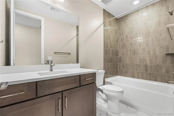 a bathroom with a sink a toilet and a bathtub