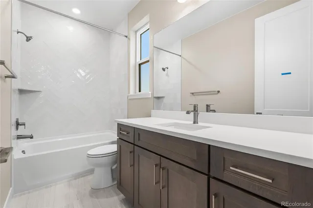 a bathroom with a sink a toilet and a bathtub